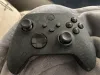 Black logo on a white controller.